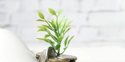 Plant grows coins from a book