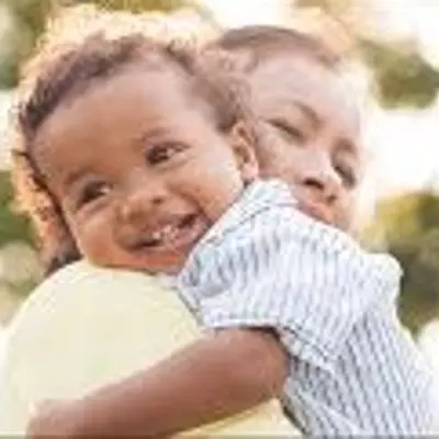Woman holds a smiling baby boy
